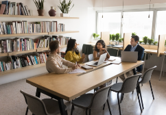 Small group of professionals meeting in a library